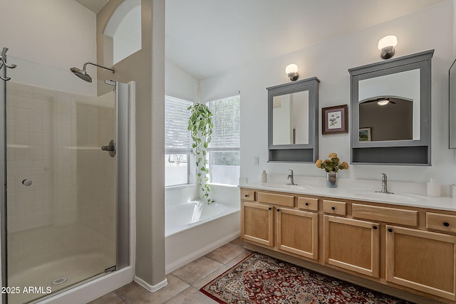 full bath featuring a bath, a sink, double vanity, and a stall shower