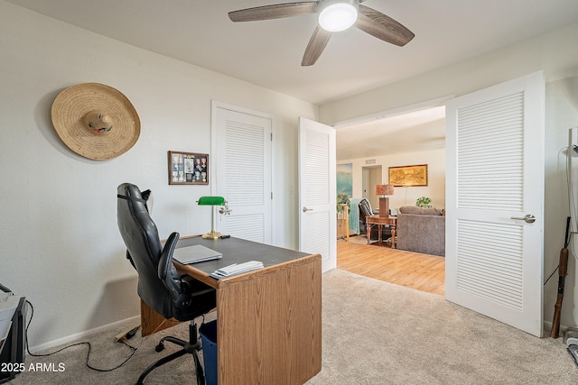 carpeted office featuring ceiling fan