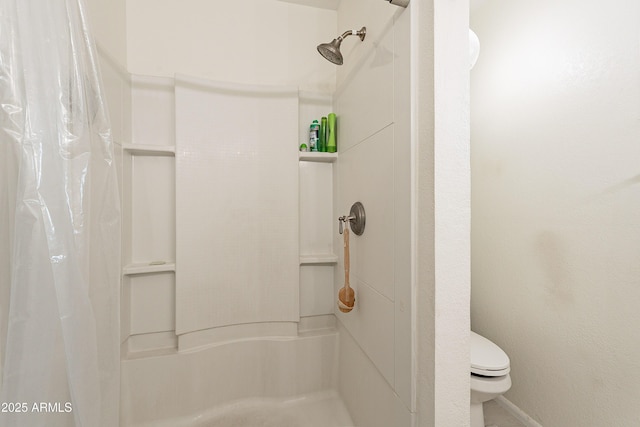 bathroom featuring toilet and a shower with shower curtain