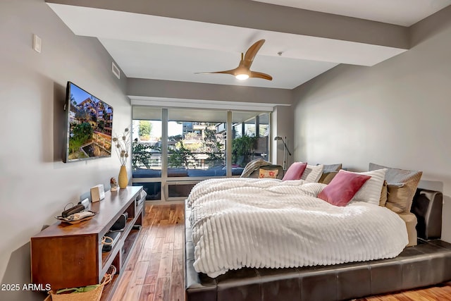 bedroom with wood-type flooring and ceiling fan