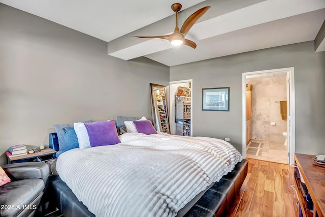 bedroom featuring ensuite bathroom, wood-type flooring, and ceiling fan