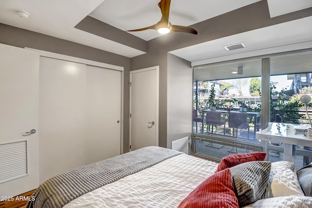 bedroom with ceiling fan and a closet