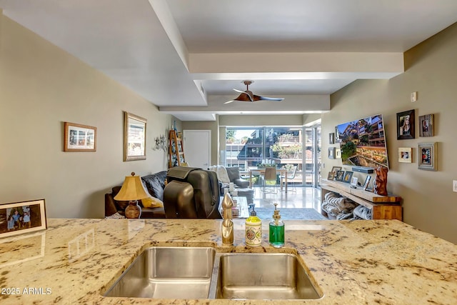 kitchen with light stone countertops and ceiling fan