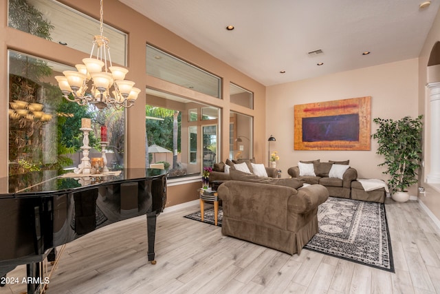 living room with a notable chandelier and light wood-type flooring