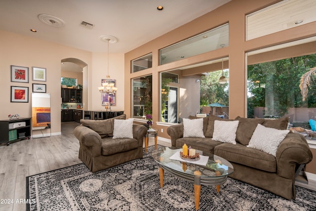 living room with a chandelier and hardwood / wood-style flooring