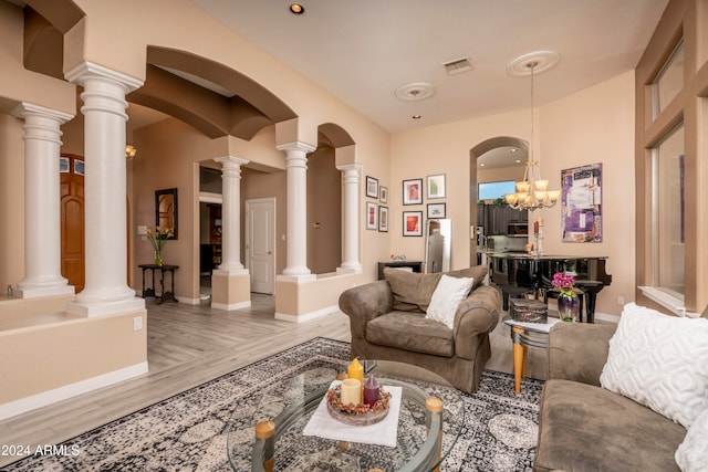 living room with a chandelier and light hardwood / wood-style floors