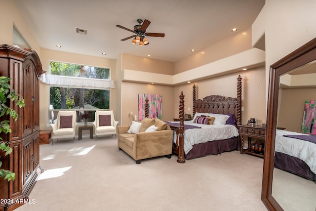 carpeted bedroom featuring ceiling fan and a towering ceiling