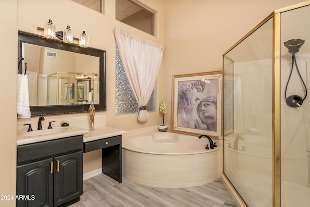 bathroom with vanity, plus walk in shower, and hardwood / wood-style flooring