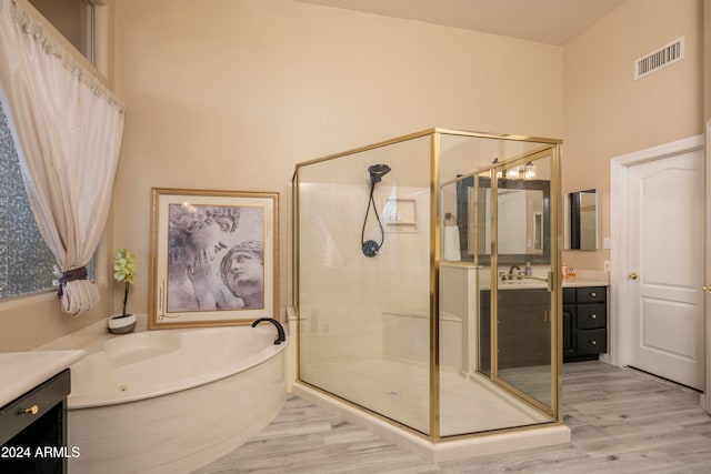 bathroom with vanity, hardwood / wood-style flooring, and separate shower and tub