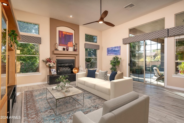 living room featuring hardwood / wood-style floors and ceiling fan