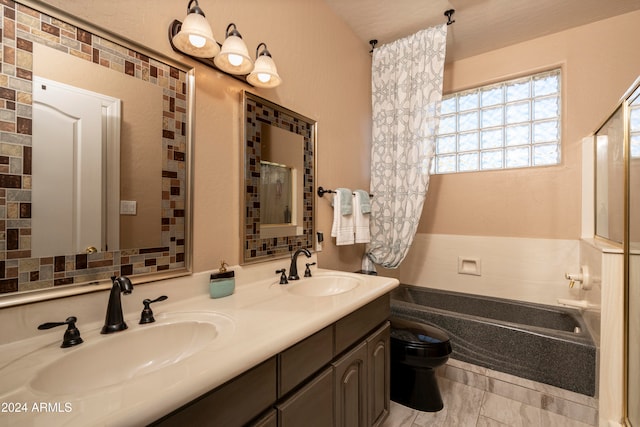 bathroom featuring a bathing tub, vanity, a textured ceiling, and toilet