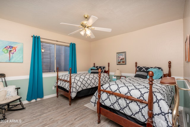 bedroom featuring ceiling fan and light hardwood / wood-style flooring