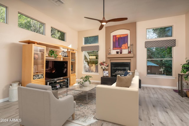 living room featuring ceiling fan and light hardwood / wood-style floors