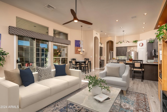 living room featuring ceiling fan and light hardwood / wood-style floors