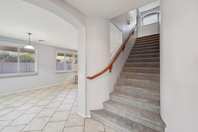 stairs featuring tile patterned floors