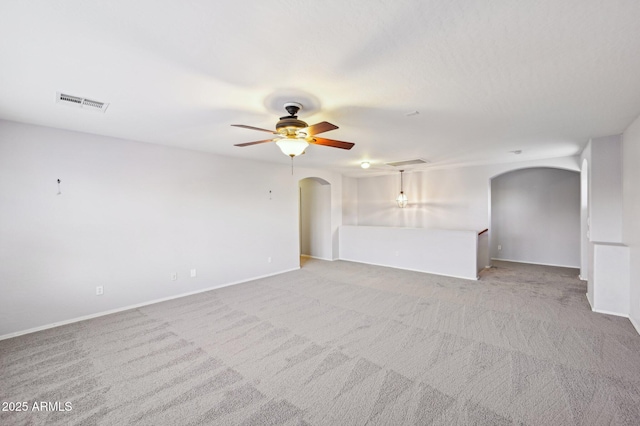 carpeted spare room featuring ceiling fan