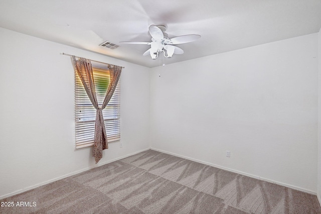 carpeted spare room with ceiling fan