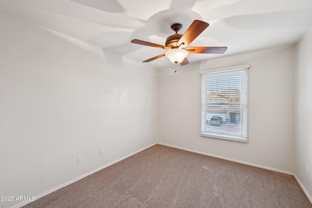 carpeted spare room with ceiling fan