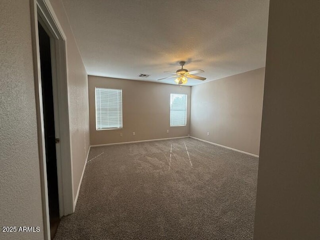 carpeted spare room with ceiling fan