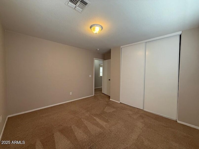 unfurnished bedroom featuring a closet and carpet flooring