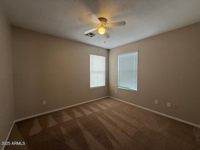 empty room with carpet floors, a textured ceiling, and ceiling fan