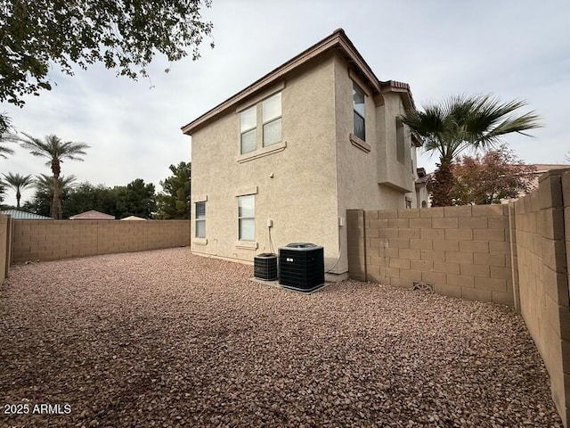 rear view of house with central air condition unit