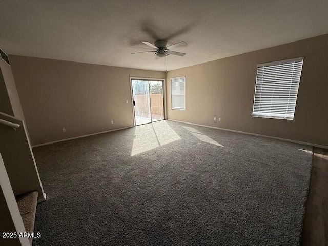 unfurnished room featuring ceiling fan and dark colored carpet