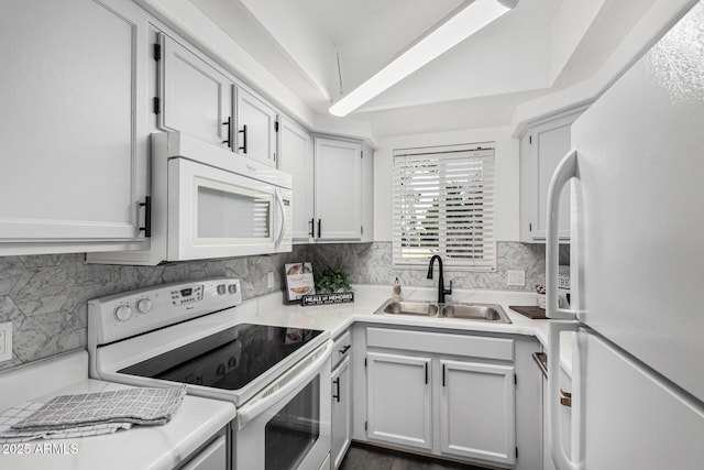 kitchen featuring backsplash, white cabinetry, sink, and white appliances