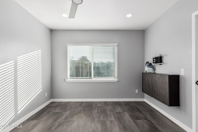 spare room with ceiling fan and dark wood-type flooring