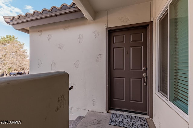 entrance to property with a balcony