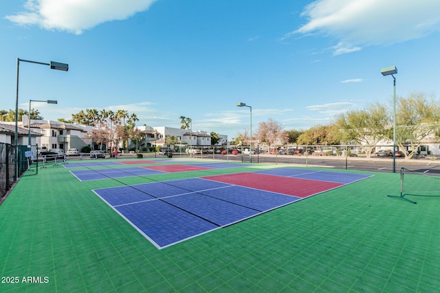 view of tennis court featuring basketball court