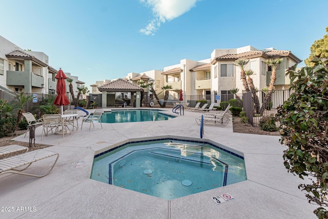 view of pool featuring a gazebo, a patio, and a hot tub