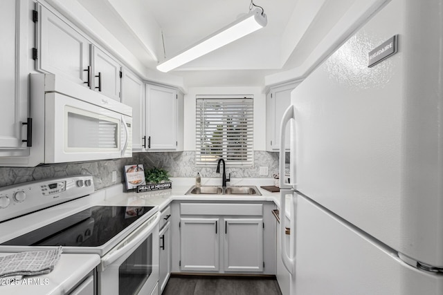 kitchen with white cabinets, white appliances, tasteful backsplash, and sink