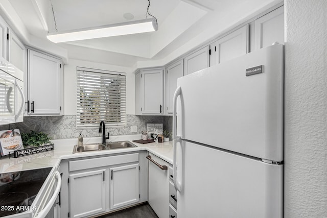 kitchen featuring backsplash, white cabinetry, and white appliances