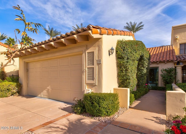 mediterranean / spanish home with a garage