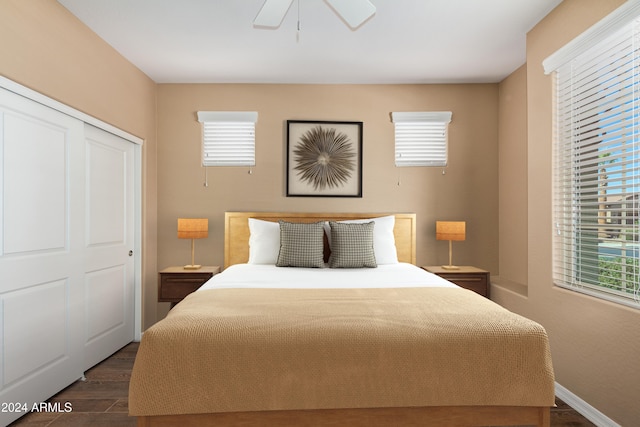 bedroom with a closet, dark hardwood / wood-style flooring, and ceiling fan