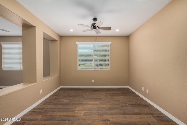 unfurnished room with dark hardwood / wood-style flooring and ceiling fan