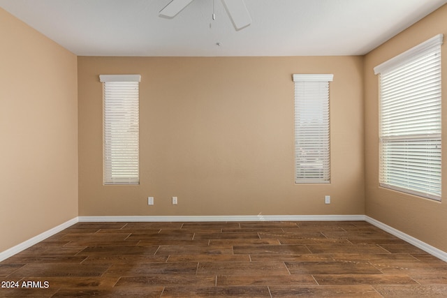 unfurnished room featuring dark hardwood / wood-style flooring and ceiling fan