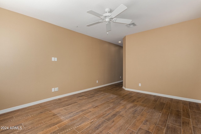 empty room with hardwood / wood-style floors and ceiling fan