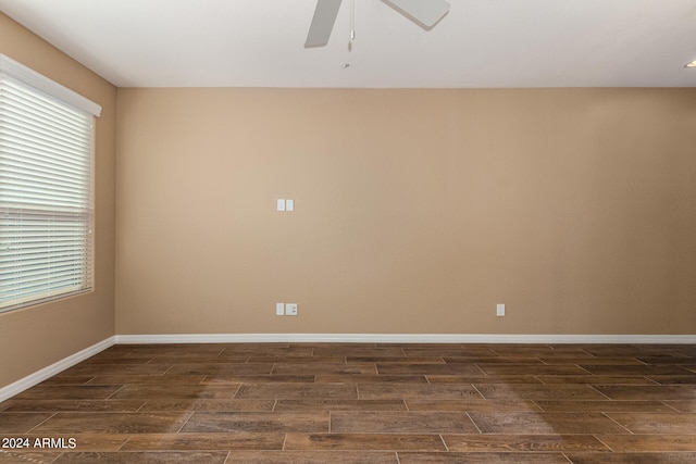 spare room with dark hardwood / wood-style floors and ceiling fan