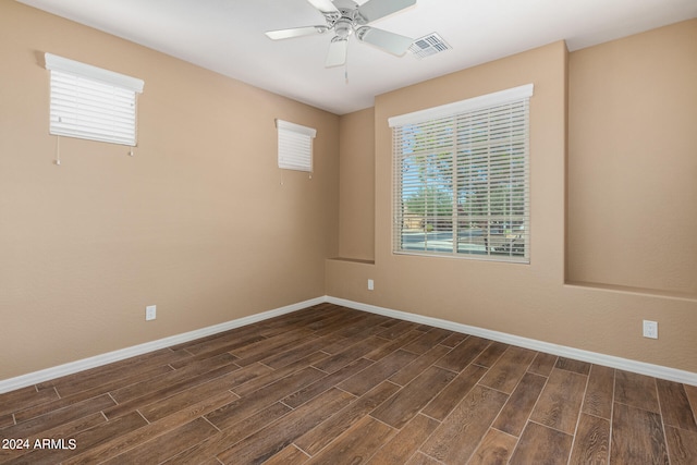 empty room featuring ceiling fan and dark hardwood / wood-style floors