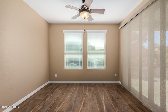 unfurnished room featuring ceiling fan and dark wood-type flooring