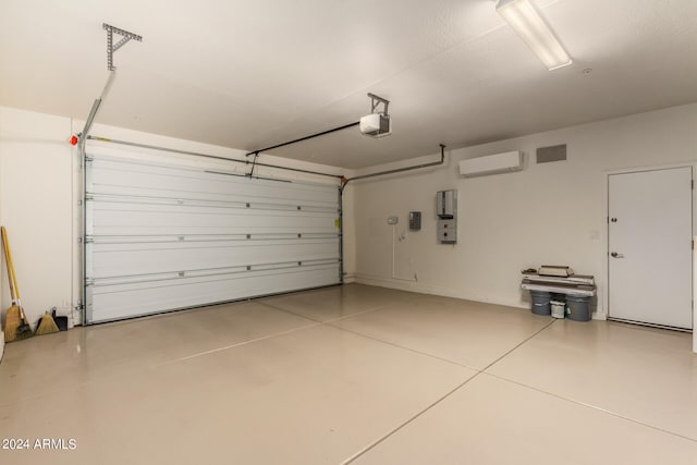 garage with a garage door opener and an AC wall unit