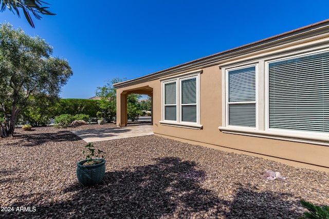 view of side of property featuring a patio