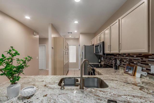 205 N 74th St Unit 166, Mesa, AZ 85207 - kitchen with stainless steel appliances, backsplash, light stone countertops, light tile patterned floors, and recessed lighting