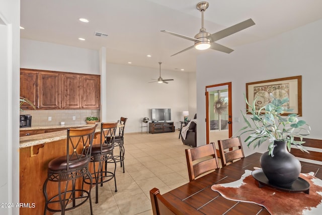 dining area with ceiling fan and light tile patterned flooring