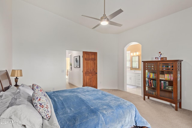 carpeted bedroom featuring vaulted ceiling, connected bathroom, and ceiling fan