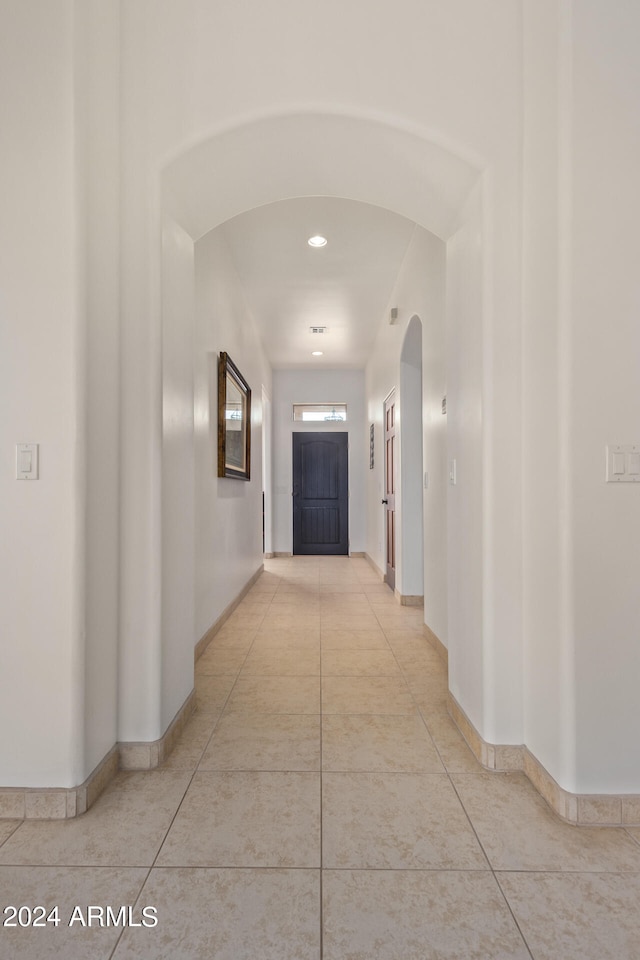 hall with light tile patterned floors