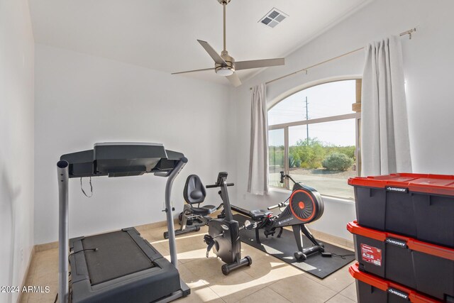 workout area with light tile patterned floors and ceiling fan