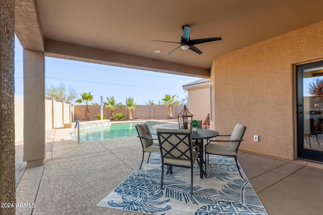 view of patio with ceiling fan and a fenced in pool